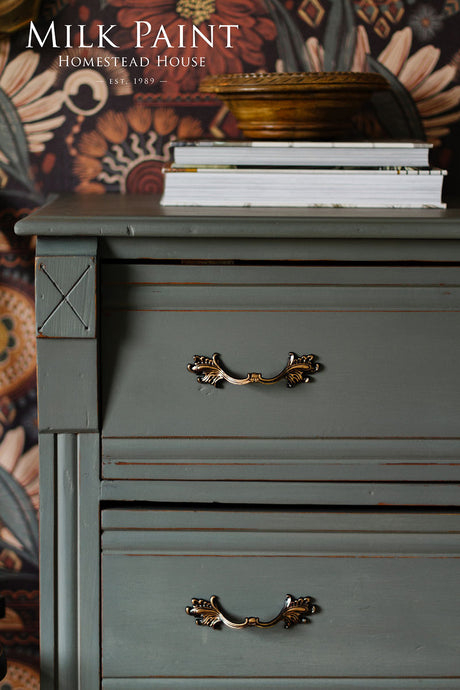 Homestead House Windsor Green dresser topped with books and a bowl.
