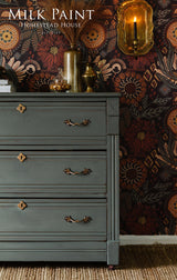 Gray dresser in Homestead House Windsor Green Milk Paint with brass handles and gold accents.