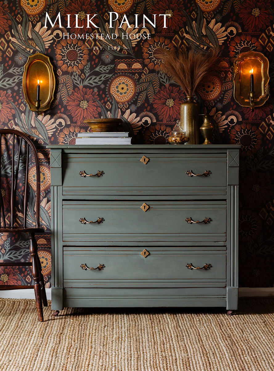 Green dresser in Homestead House Windsor Green Milk Paint with brass handles, chair and decor on top.