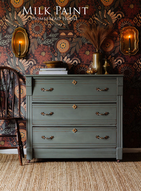 Green dresser in Homestead House Windsor Green Milk Paint with brass handles, chair and decor on top.