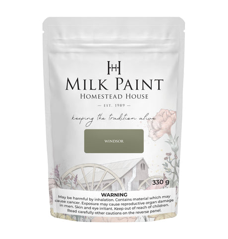 Homestead House Windsor Green Milk Paint, 330g pouch with floral and barn design; warning label at bottom.