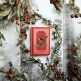 Red book with bird, featuring I.O.D.’s Winter Botanist Transfer 2025 Limited Release and vintage decor accents.