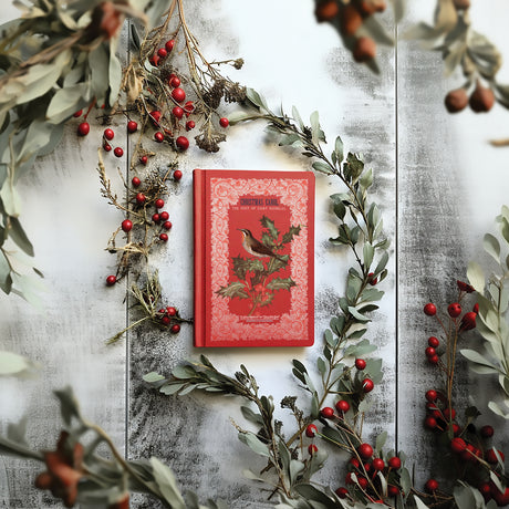 Red book with bird, featuring I.O.D.’s Winter Botanist Transfer 2025 Limited Release and vintage decor accents.