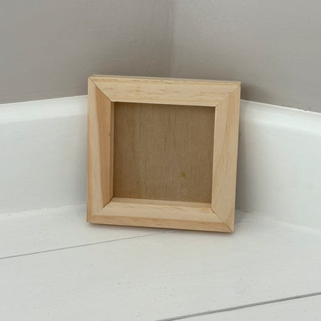 I.O.D. Wood Gallery Blank by Iron Orchid Designs standing upright against a gray wall on a white floor.