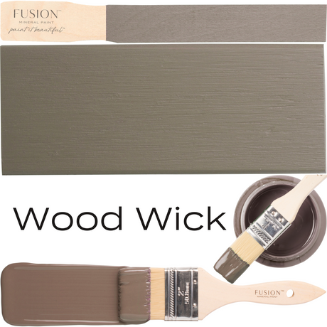 Paintbrush, brown Wood Wick Fusion Mineral Paint can, painted wood sample, and “Wood Wick” text shown.
