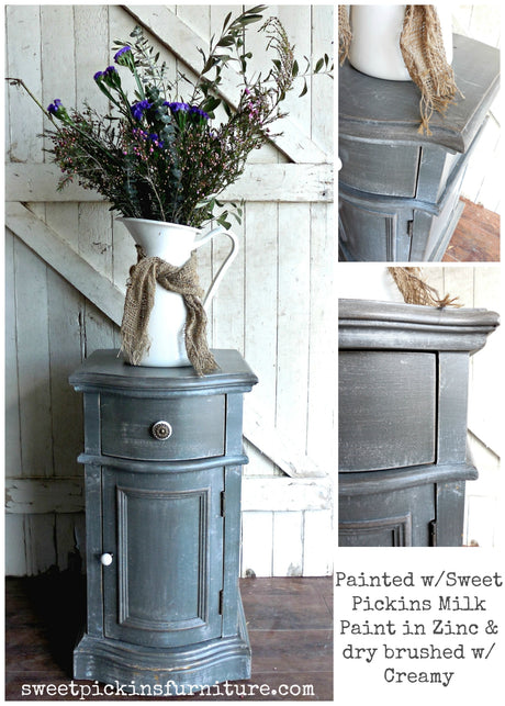 Zinc by Old Fashioned Milk Paint on wood, shown with rustic fabrics highlighting the paint’s finish.