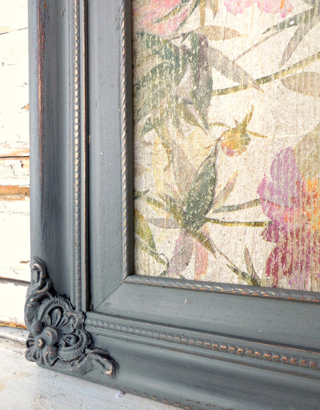 Gray ornate frame in “Zinc” by Old Fashioned Milk Paint with floral art enclosed.