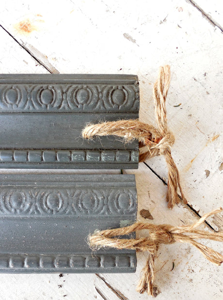Two trims painted with Zinc by Old Fashioned Milk Paint, tied with twine.