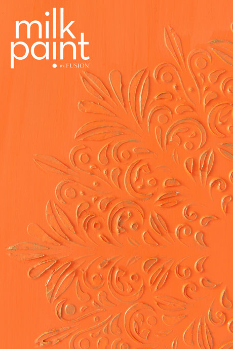 Embossed floral design on orange Aperol Spritz Milk Paint by Fusion Mineral Paint, text at top left corner.