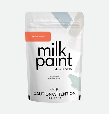 Fusion Mineral Paint Aperol Spritz Milk Paint, 50g white resealable pouch, irritant and Bonding Agent noted.