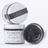 Three jars of Fusion Mineral Paint Black Furniture Wax, one open showing the black wax inside.