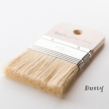 The Dusty Paintbrush by Paint Pixie with light bristles and wood handle marked 70 placed near the word Dusty.