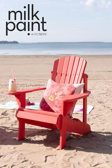 Red Adirondack chair painted with Fusion Mineral Paint Hawaiian Hibiscus Milk Paint on sand.