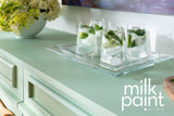 Three clear drinks with mint on Fusion Mineral Paint Mojito Milk Paint-green cabinet beside a floral bowl.