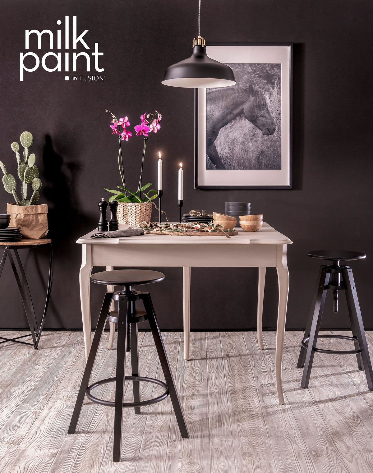 Small table with black stools, candles, plants; horse photo on wall; Fusion Mineral Paint “Oyster Bar” in corner.