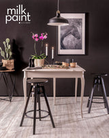 Small table with black stools, candles, plants; horse photo on wall; Fusion Mineral Paint “Oyster Bar” in corner.