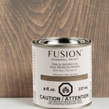 Fusion Mineral Paint Stain & Finishing Oil - All In One can in Driftwood on wood grain background.