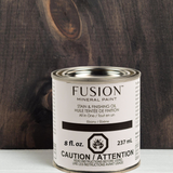 Fusion Mineral Paint Stain & Finishing Oil can with caution text visible on the label.