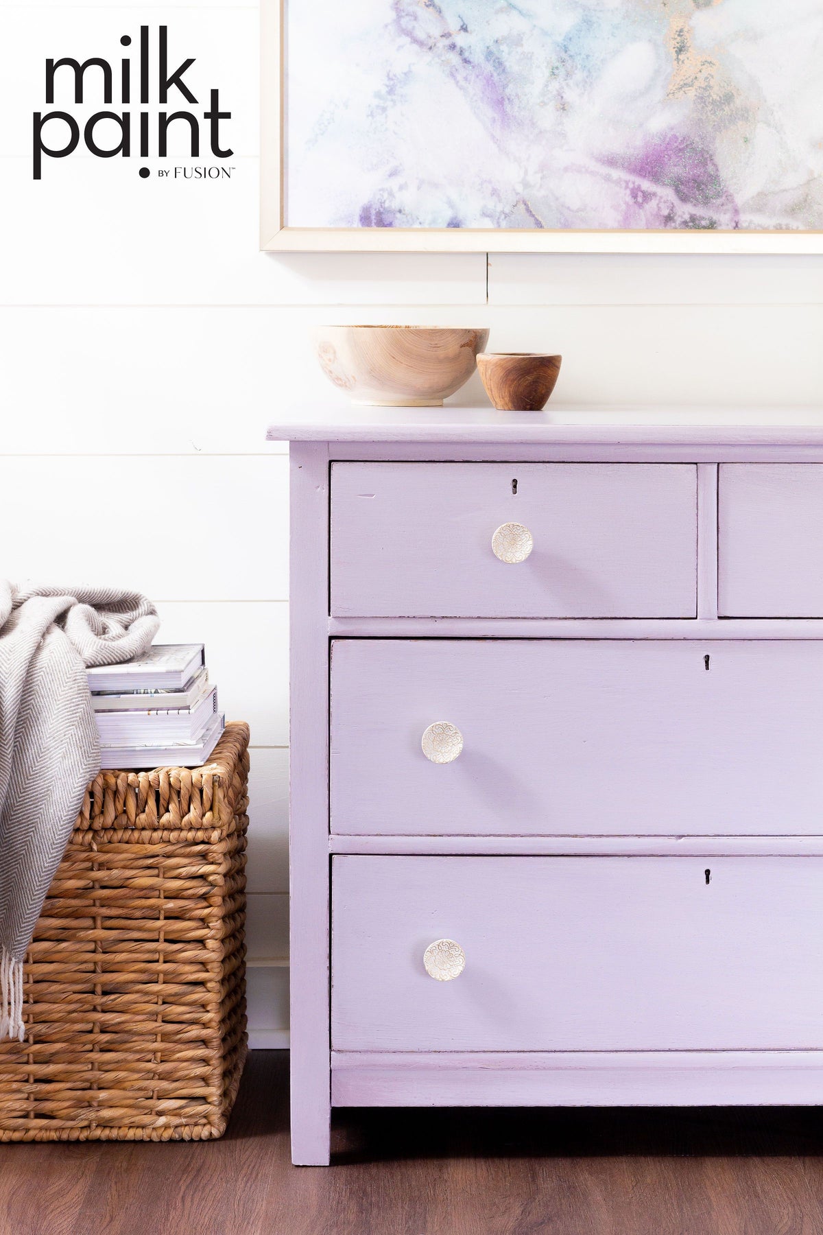 Lavender three-drawer dresser painted in Wisteria Row by Fusion Mineral Paint, with bowls on top and basket beside.